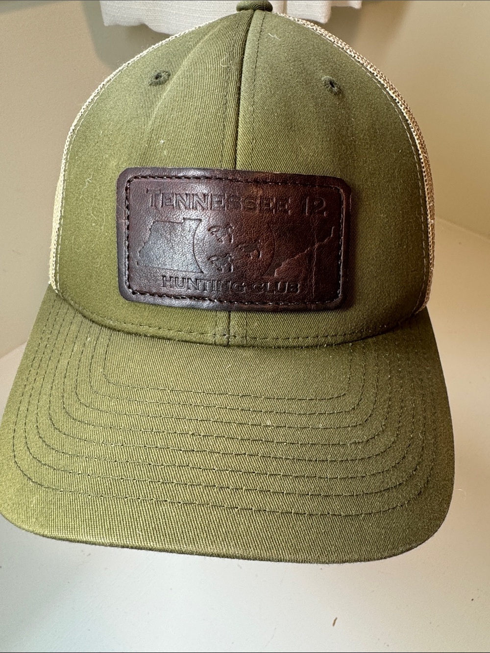 Tennessee 12 Hunting Club hat with adjustable back. Green/cream w/brown patch.
